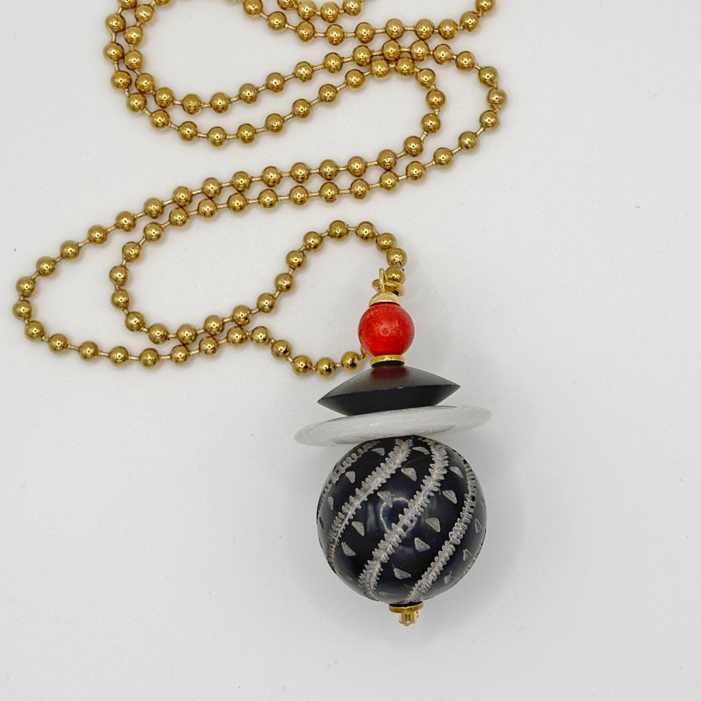Detalle de la esfera de hueso negro tallado con espirales blancas del Collar Peonza – TideStone